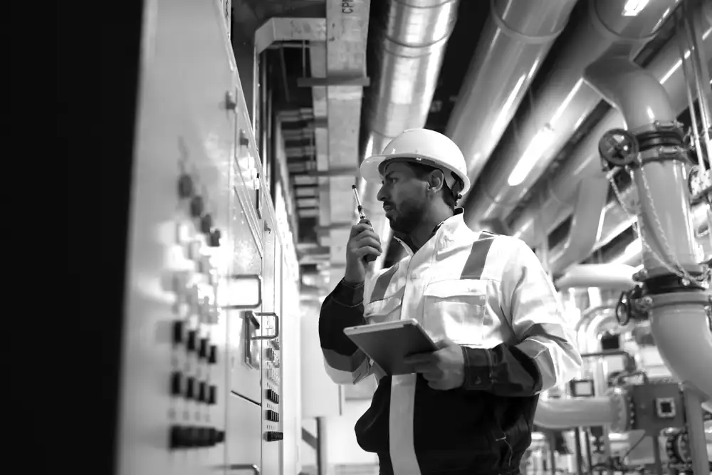 A technician working at a control panel